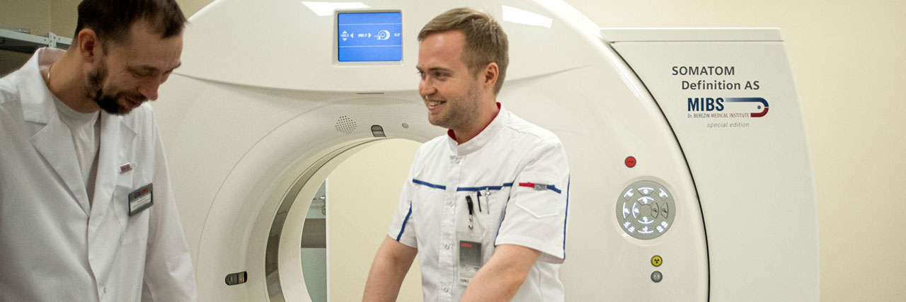 Doctors using a CT scanner prepare a proton treatment plan