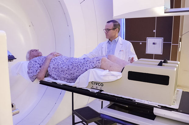 The doctor puts the patient on the gentry treatment table at the proton therapy center